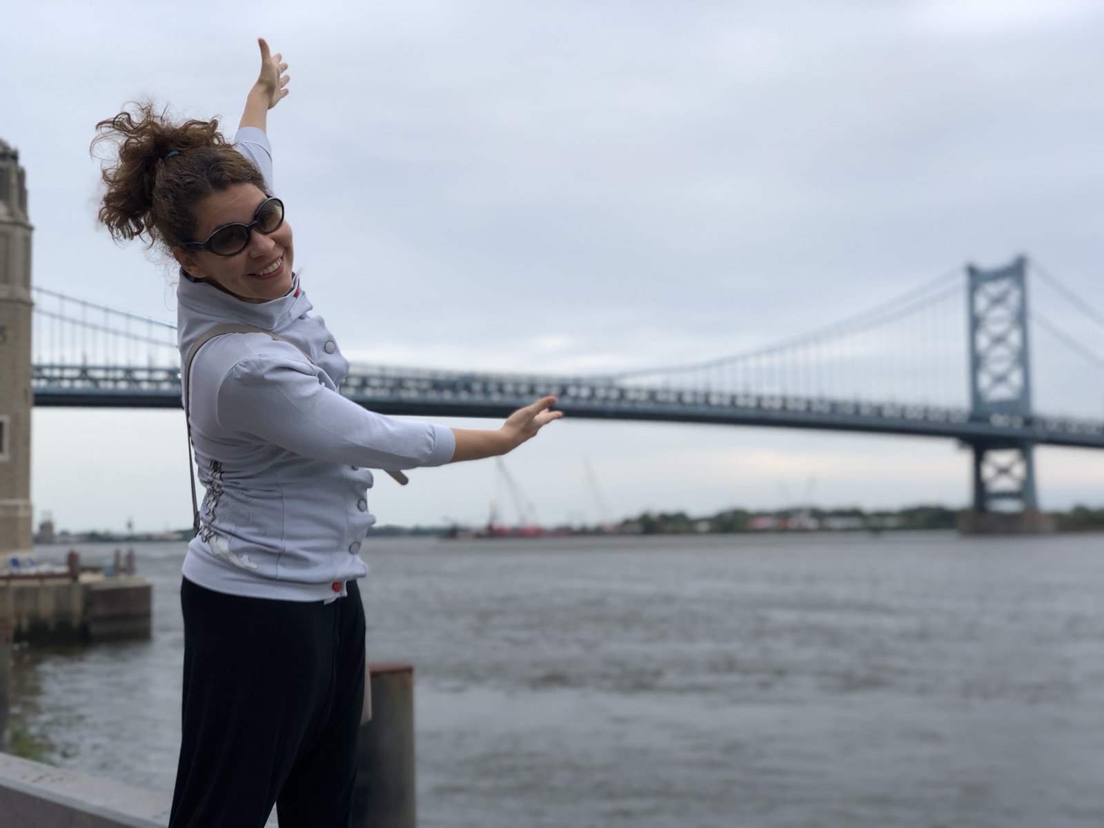 Leticia with arm extended by the bay